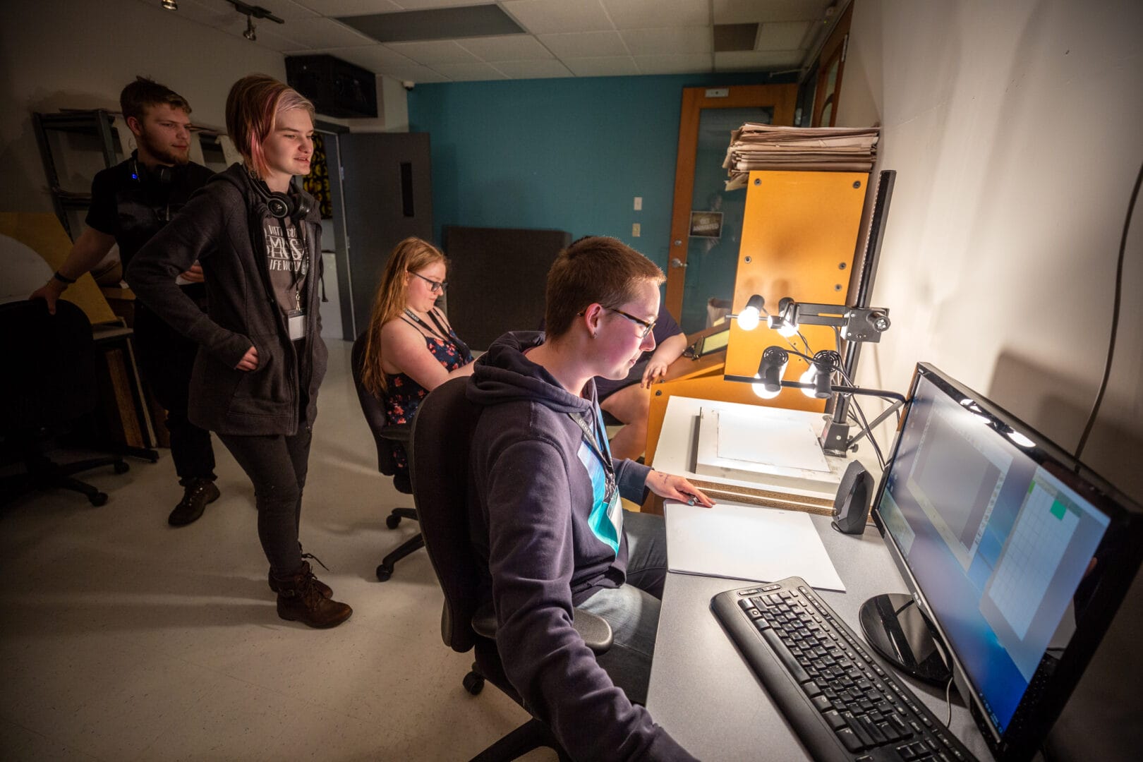 Animation students at College for Arts and Technology gather around the capture station in the animation classroom. 