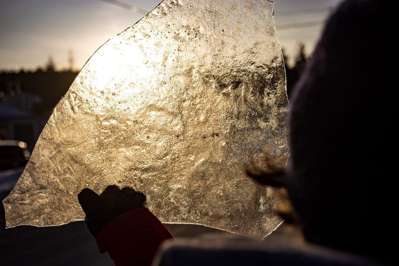 Ice Chunk being held up and reflecting sunset light.